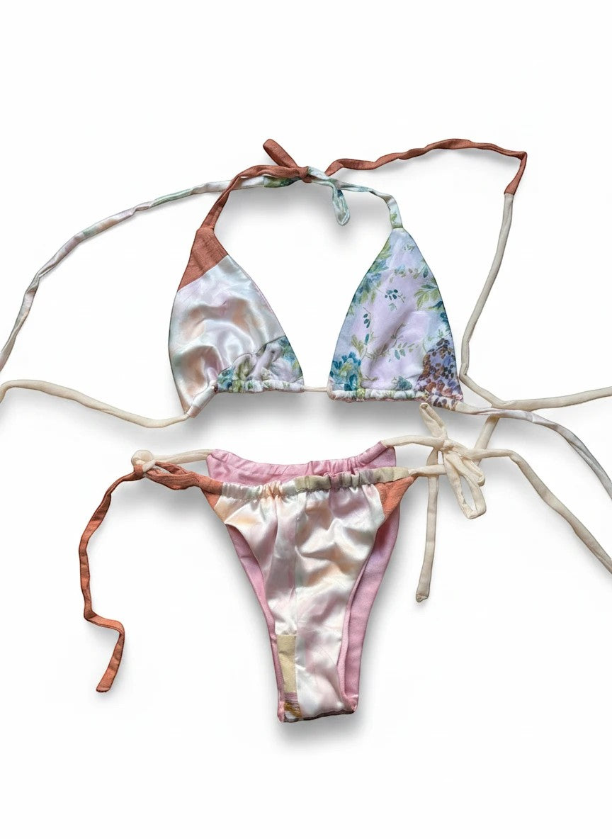 Thoughts Reworked patchwork bikini set with floral prints in pink, peach, and cream. Halter top and tie-side bottoms.