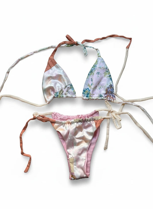 Thoughts Reworked patchwork bikini set with floral prints in pink, peach, and cream. Halter top and tie-side bottoms.