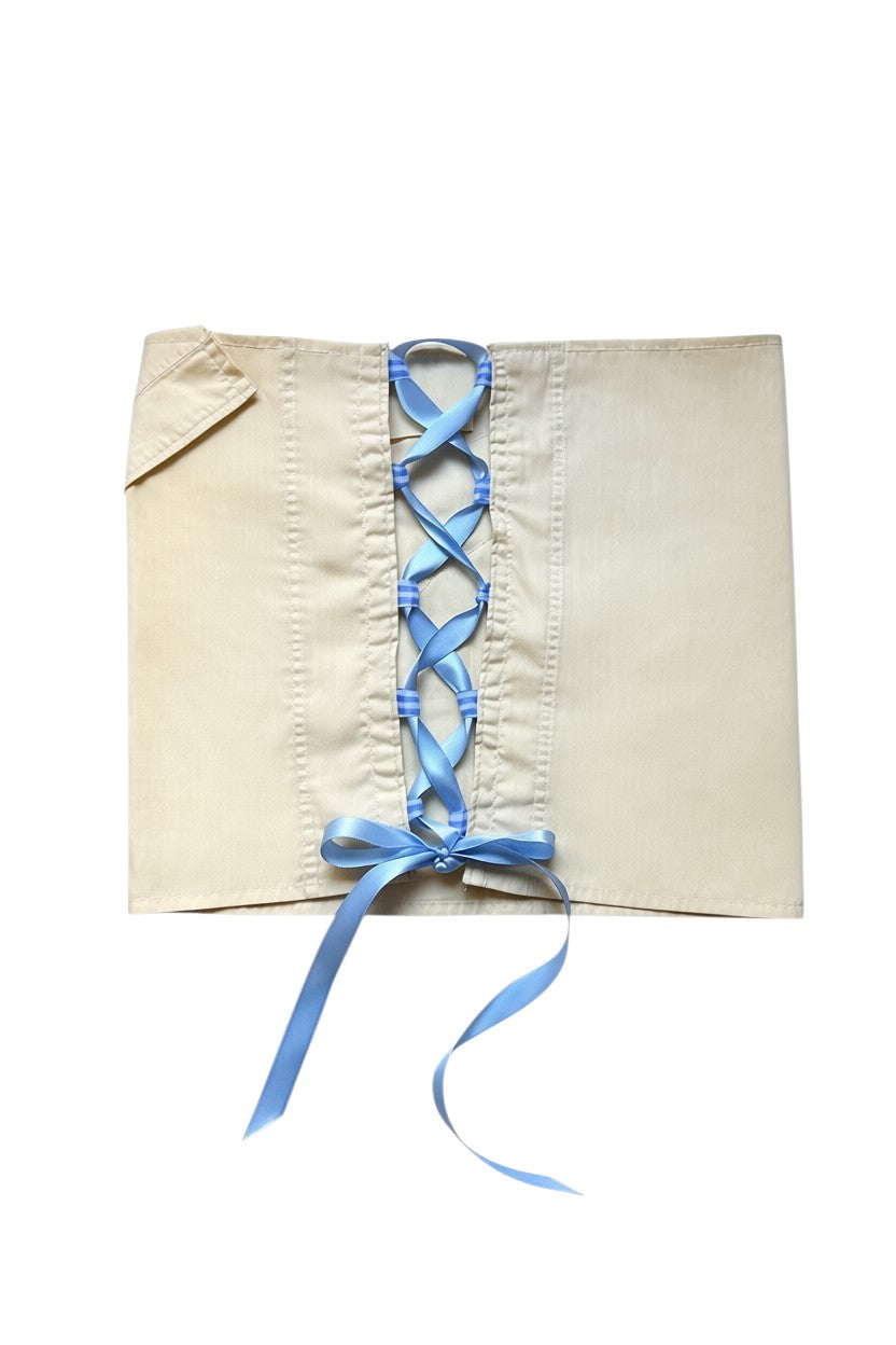 Thoughts Reworked beige cotton blend asymmetrical wrap skirt with blue lace-up ribbon detail and button closure.