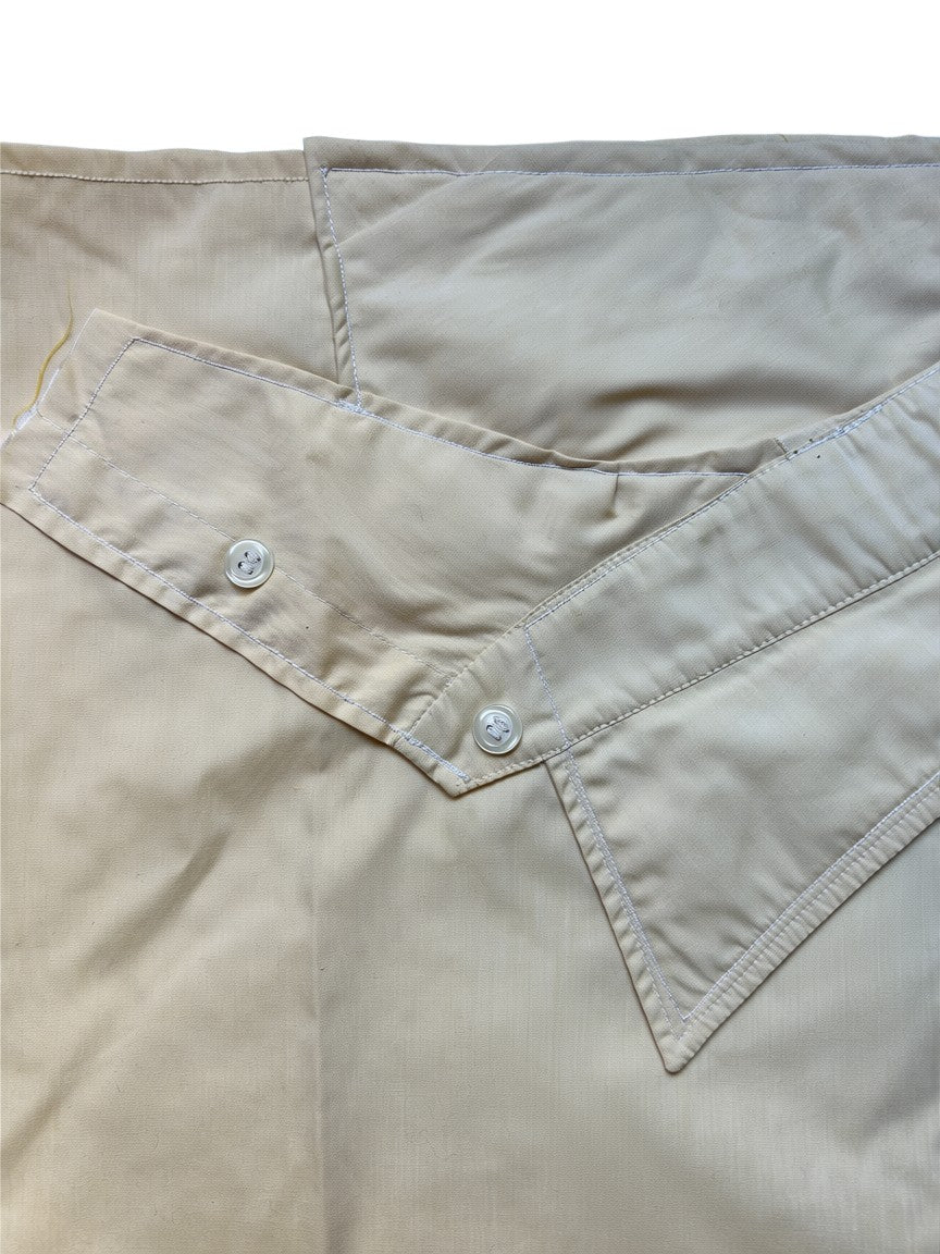 Thoughts Reworked beige asymmetrical button front skirt made from cotton blend with wrap-around design and two button closures.