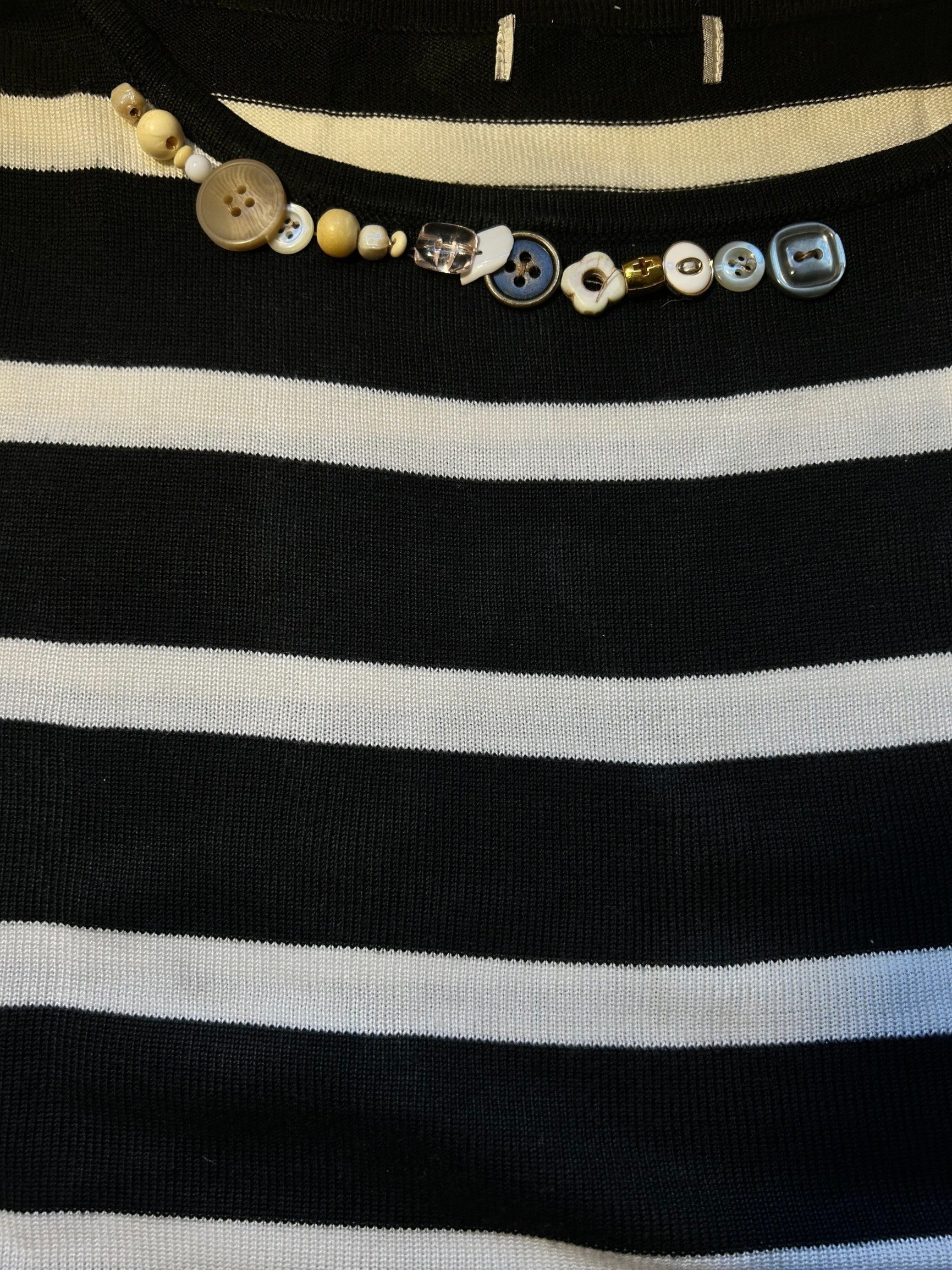 Thoughts Reworked black and white striped knit sweater with button and bead embellishment around the crew neck.