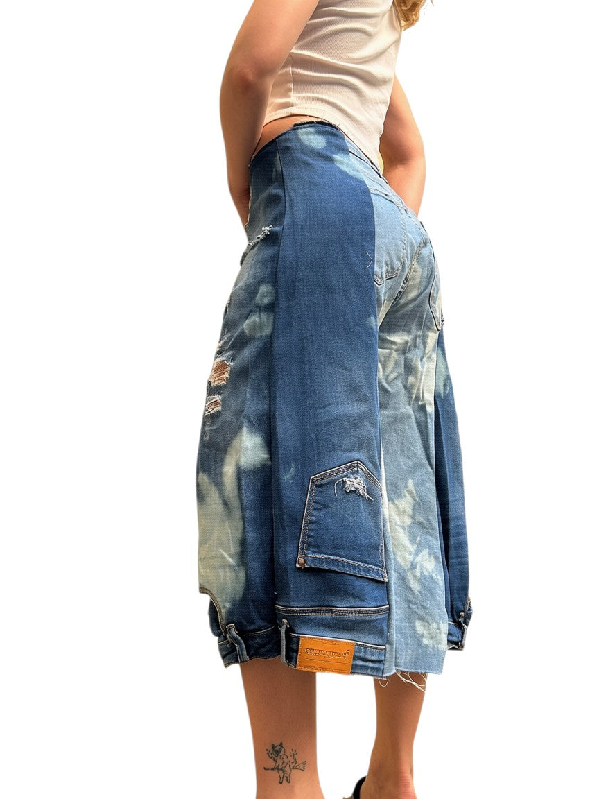 Thoughts Reworked blue and bleached denim patchwork jorts with distressed details and cargo pockets.