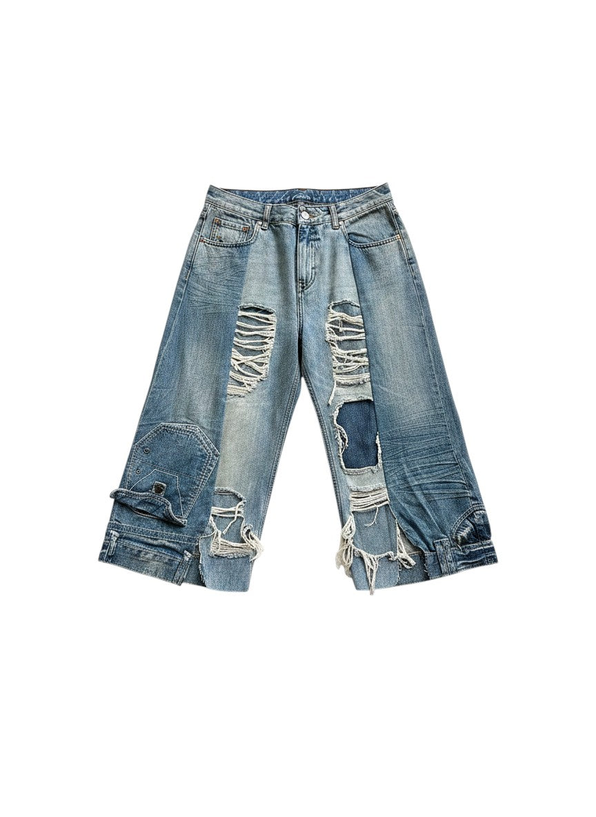 Thoughts Reworked blue distressed denim jorts with ripped details and unique patchwork design. One-off upcycled piece.
