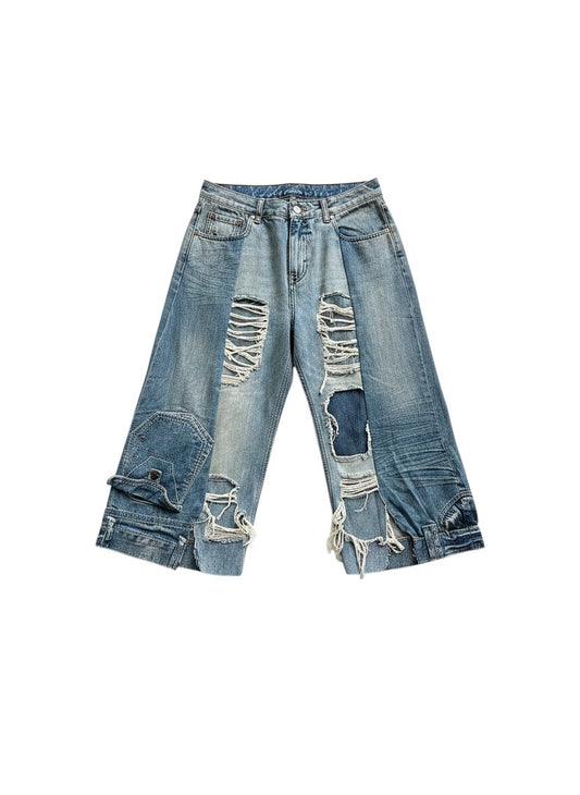 Thoughts Reworked blue distressed denim jorts with ripped details and unique patchwork design. One-off upcycled piece.