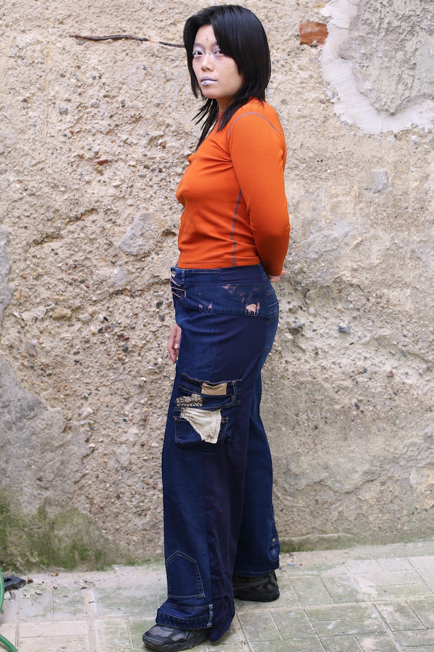 Thoughts Reworked dark wash denim cargo jeans with patchwork details and wide legs. Model is size L, 1.70m tall.