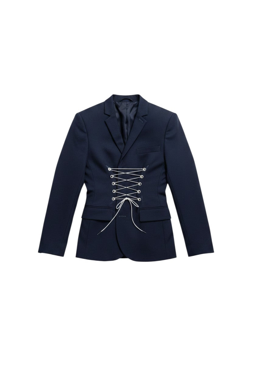 Thoughts Reworked navy blue reworked blazer with corset lacing detail, worn by a model with light wash denim jeans.