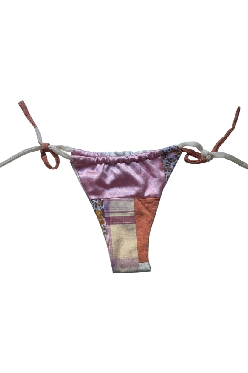 Thoughts Reworked patchwork bikini swimsuit with floral and solid panels in pink, peach, and cream. Adjustable ties.