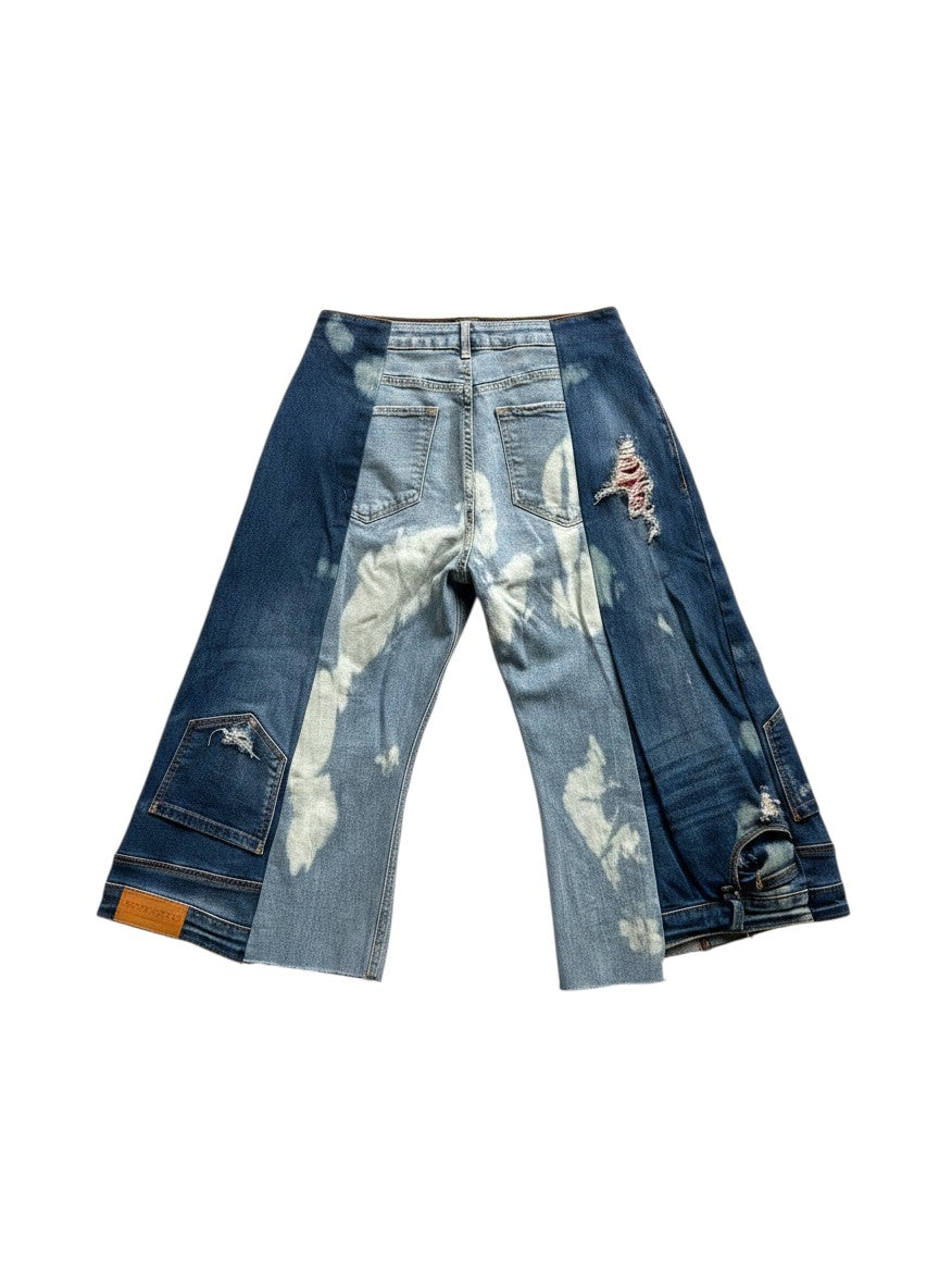 Thoughts Reworked patchwork bleach denim jorts with distressed details and raw hem. Model is 1.60m tall.