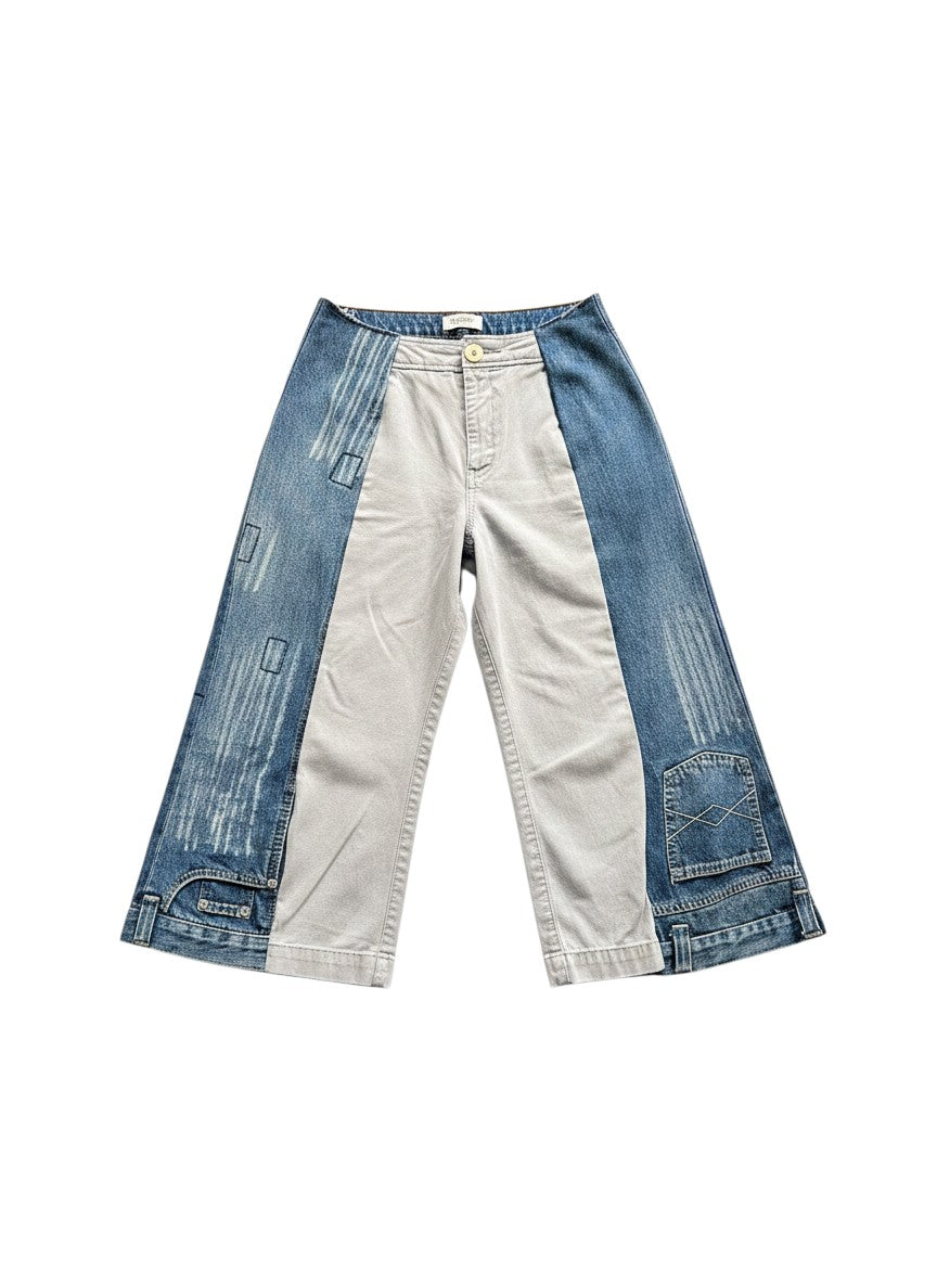 Thoughts Reworked blue and grey patchwork denim jorts with a wide leg and cropped length, worn by a model.