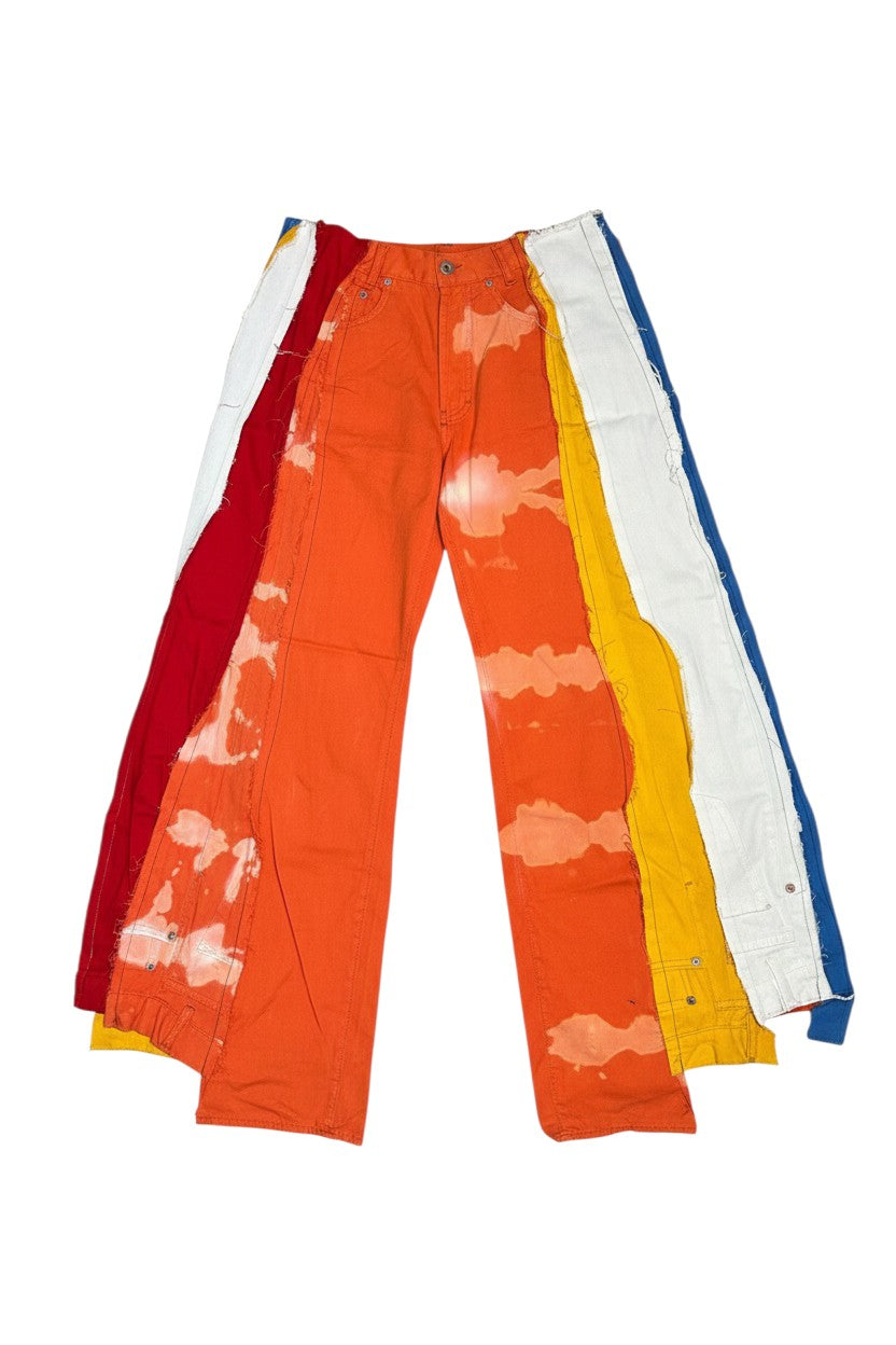 Thoughts Reworked upcycled patchwork wide leg denim jeans in orange, red, blue, yellow, and white with deconstructed design.