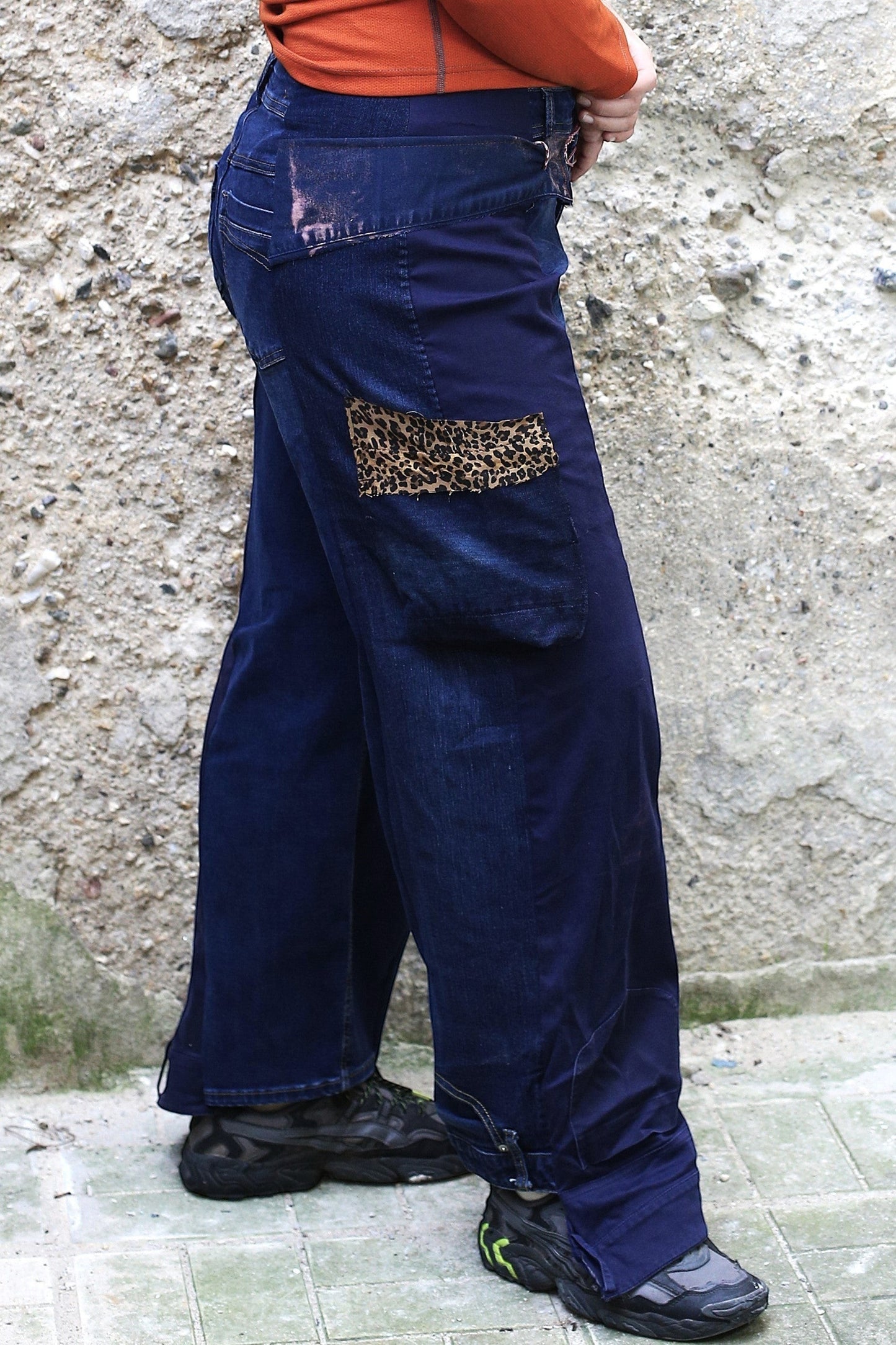 Thoughts Reworked dark wash denim cargo jeans with wide leg and leopard print patch detail.