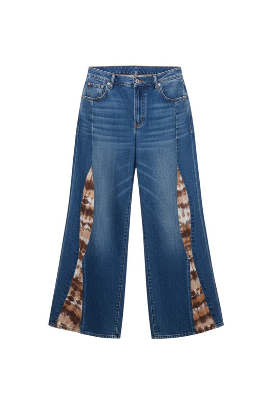 Thoughts Reworked wide leg jeans with patchwork fabric inserts, model wearing orange top.