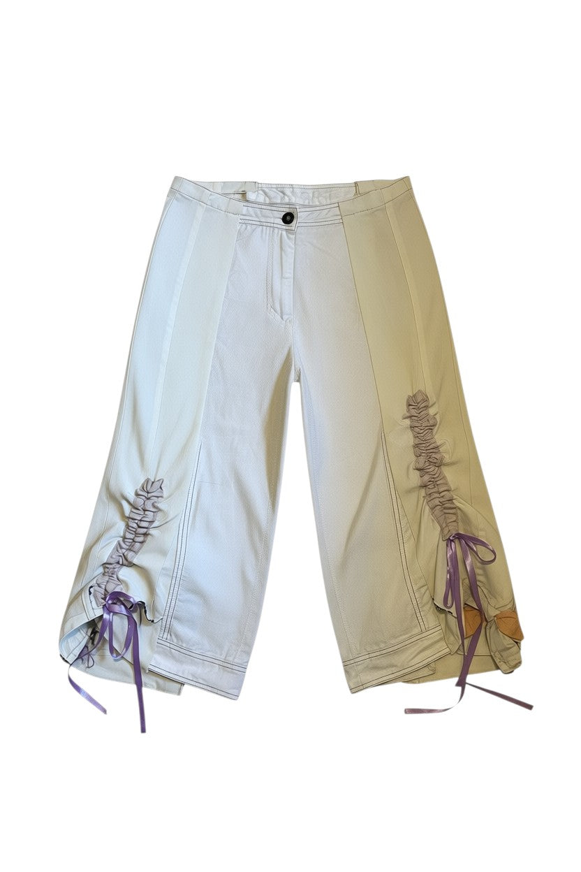 Thoughts Reworked off-white wide leg cropped pants with asymmetric panels and lilac ribbon drawstring detail.