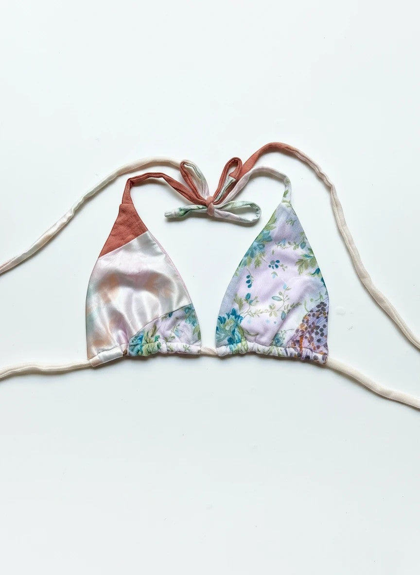 Thoughts Reworked patchwork bikini top with floral and satin panels in pink, peach, and cream. Halter neck with tie closure.