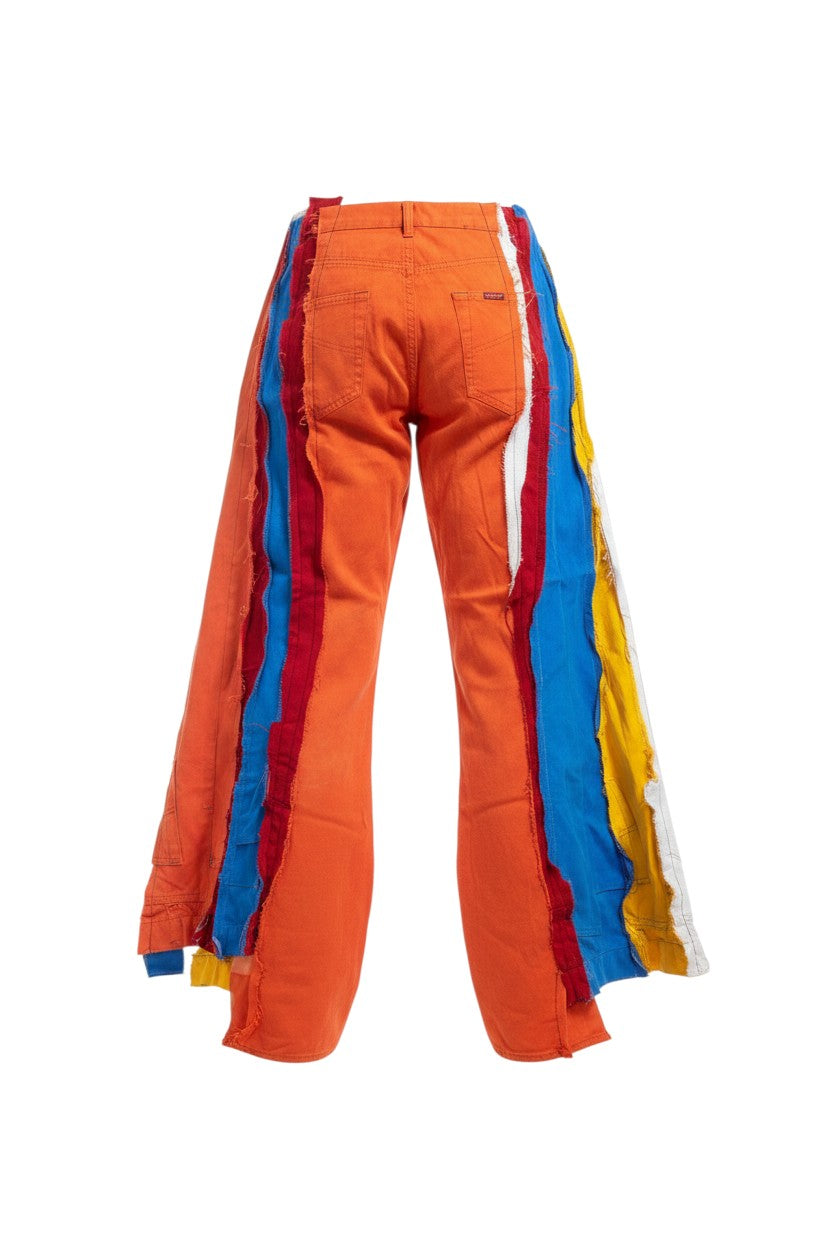 Thoughts Reworked patchwork wide leg denim jeans in orange, red, blue, yellow, and white. Deconstructed, upcycled design.